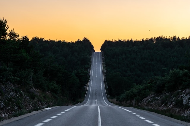 Open road stretching to the horizon at sunset